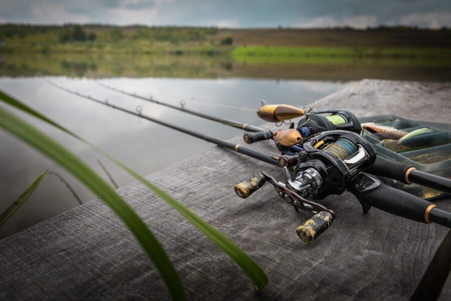 Fishing rods on a wooden dock at the lake 