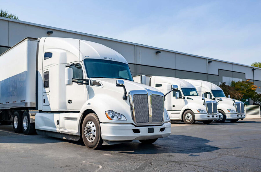 Three white moving trucks
