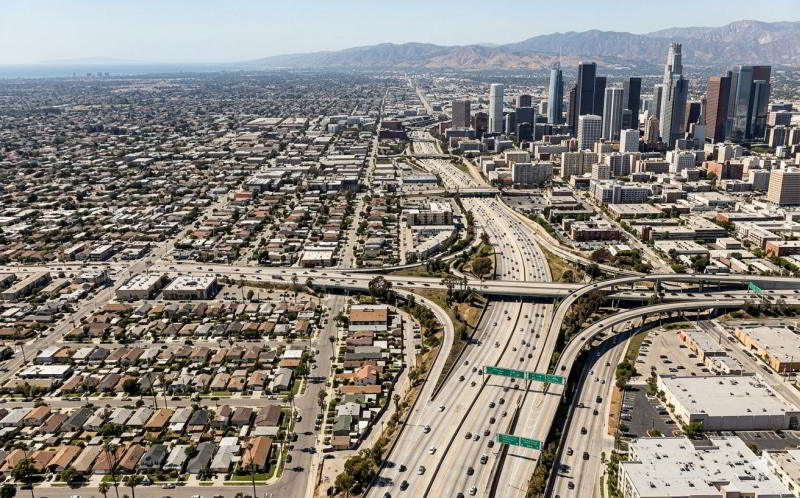 Aerial or wide-angle photo of downtown LA or a residential neighborhood showing the sprawl — illustrates the "geographic complexity" point.