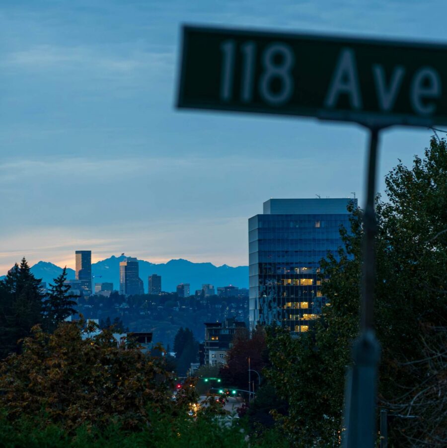 A street sign on Columbia Street in Seattle with the downtown skyline and Space Needle in the background.